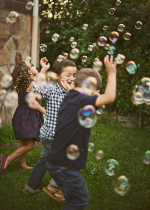 Children playing in bubbles