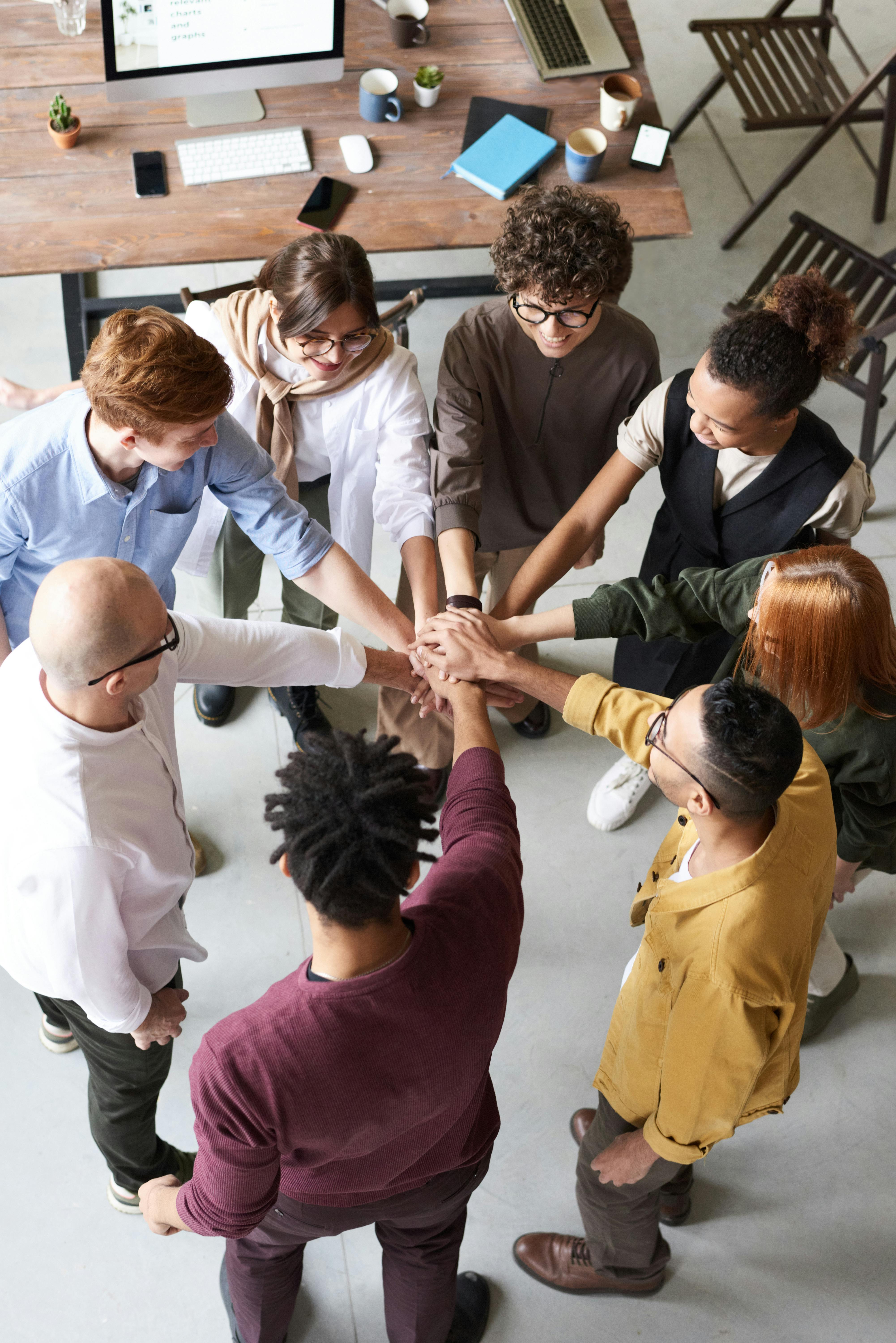 A team of lecturers standing in a circle